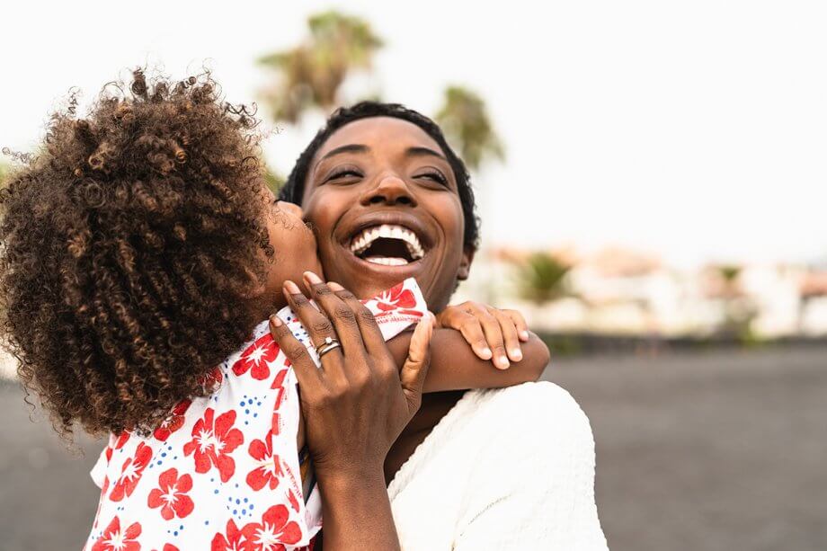 woman and child hugging and smiling