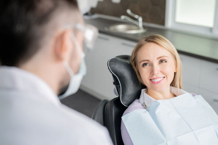 female dental patient smiling at dentist