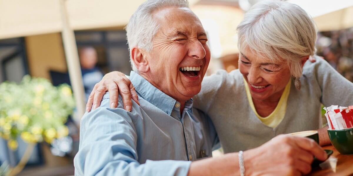 senior couple having coffee and laughing