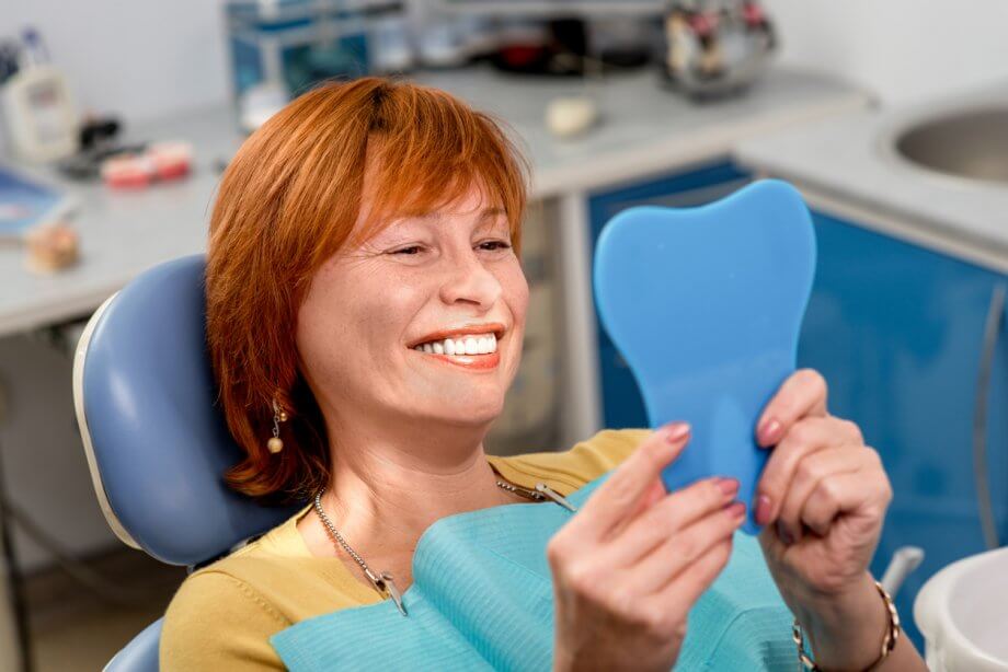 Senior Woman Admiring New Dental Implants