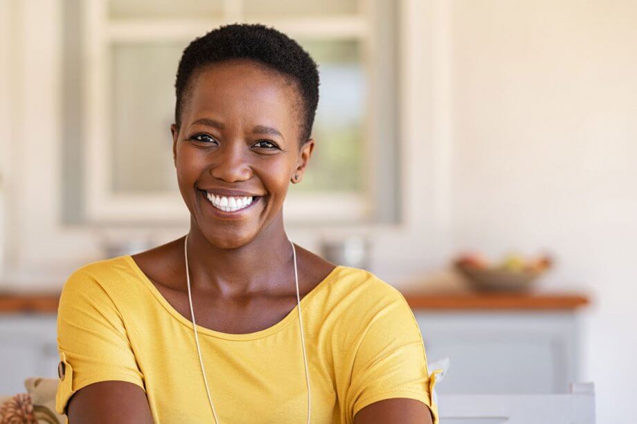 woman in yellow shirt smiling